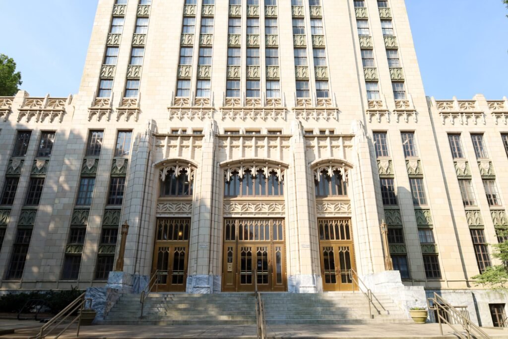 A photograph of the entrance to Atlanta City Hall, with white stone walls and golden doors.